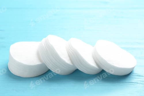 Preview: Cotton pads on wooden background. Hygienic product
