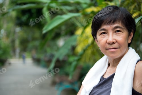 Preview: Senior Asian woman in park