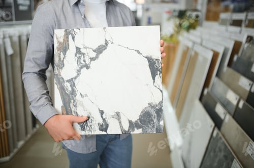 Preview: Male customer choosing kitchen ceramic tile in store