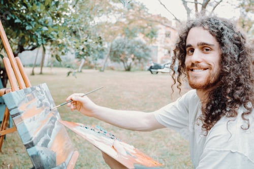 Preview: Portrait of Artist Working. Close-up Shot portrait, long hair young man painting oil