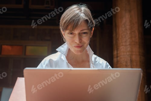 Preview: Woman is working remotely on laptop