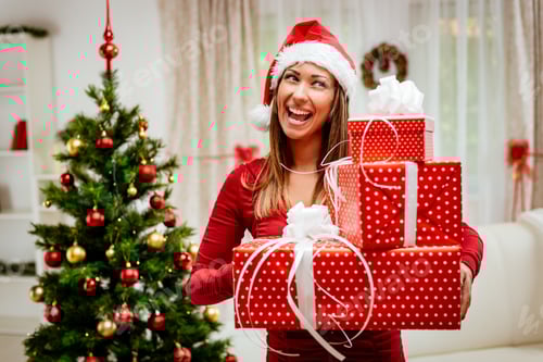 Preview: Woman with Christmas Gifts Smiling in Decorated Home