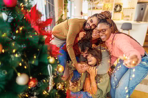 Preview: Friends having fun decorating Christmas tree