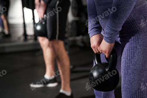 Preview: Close-up photo of female and man exercising in fitness club