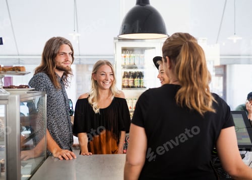 Preview: Friends talking with waitress at restaurant counter
