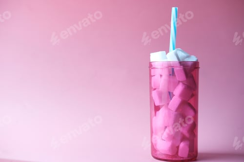 Preview: sugar cube in a plastic container on pink background