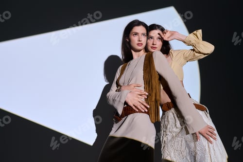 Preview: Stylish twin sisters showcase their fashion sense under dramatic lighting