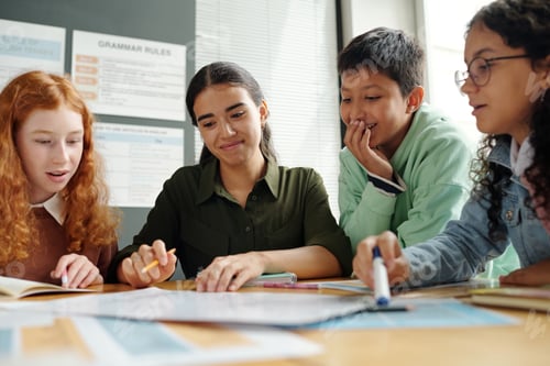 Preview: Group of clever schoolkids and their teacher discussing new grammar rules