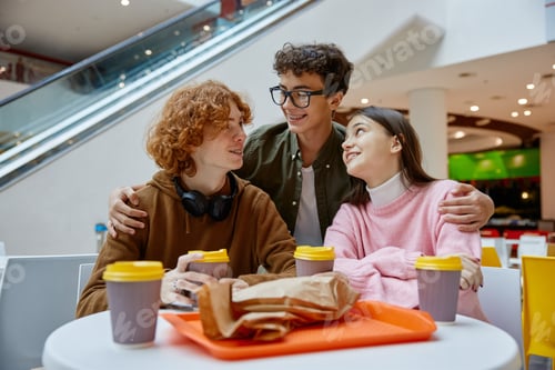 Preview: Teen friends having snack during walk in shopping center