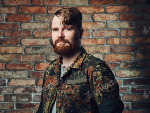 Preview: Redhead male over the wall of a brick.