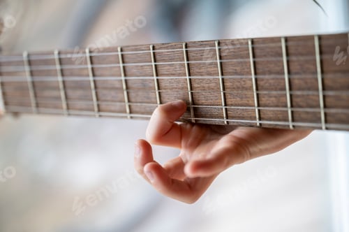 Preview: Child learning guitar chords