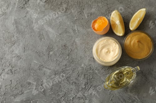 Preview: Jar with mayonnaise and ingredients for cooking on gray background, top view