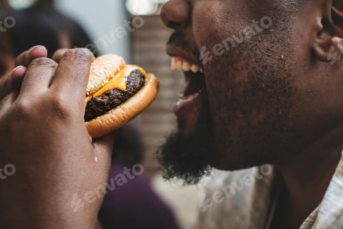 Preview: Man eating a big hamburger