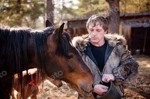 Preview: a man feeding a horse with oats