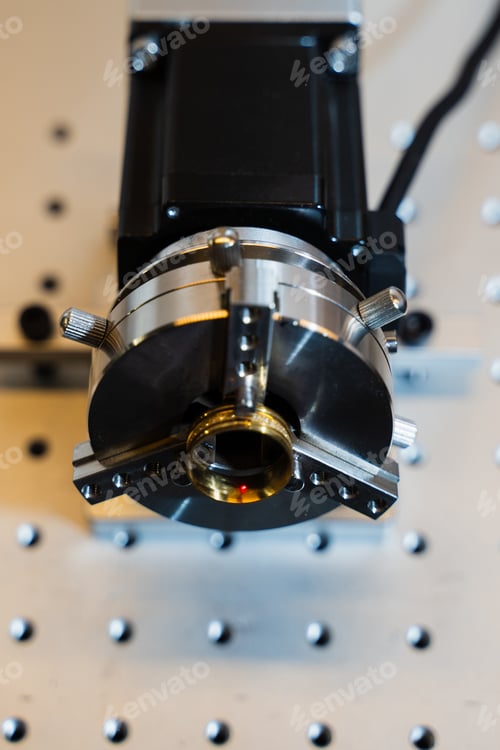 Preview: Artisan using a laser to engrave a gold ring.