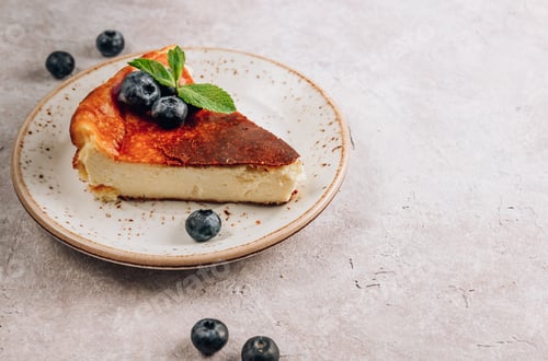 Slice of Basque Cheesecake with Fresh Blueberries