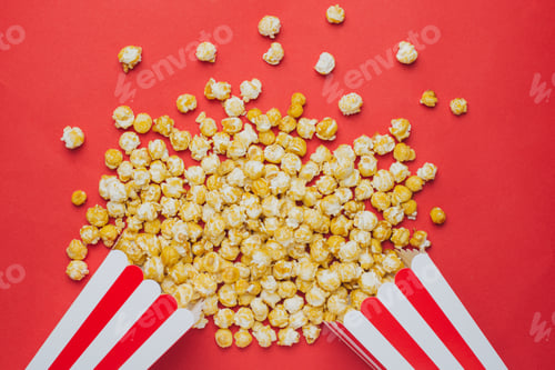 Preview: Popcorn on a red background top view in cinema