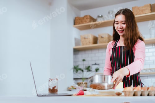 Preview: Streaming Culinary, Woman Making and Decorating a Cake in the Kitchen, Connected through Laptop