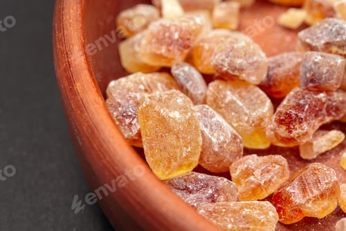 Preview: brown sugar rock organic crystalline close up on dark background