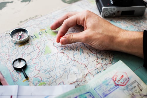 Preview: Closeup of hand pinning on world map journey travel