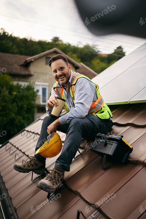 Preview: Happy maintenance engineer enjoying on coffee break on the roof.
