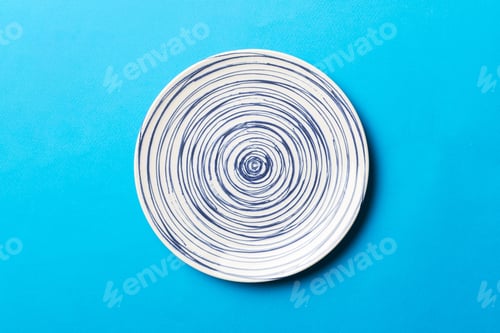 Preview: Top view of isolated of colored background empty round blue plate for food. Empty