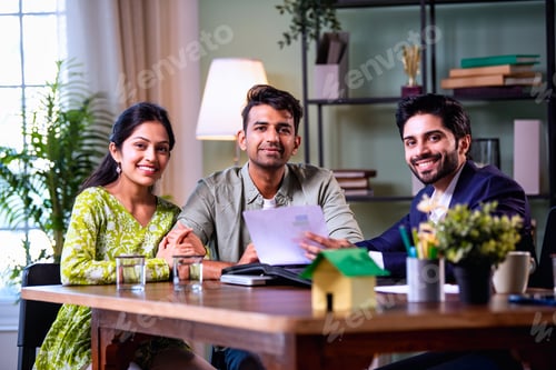 Preview: Indian family investment consultation at home with professional agent reviewing paperwork
