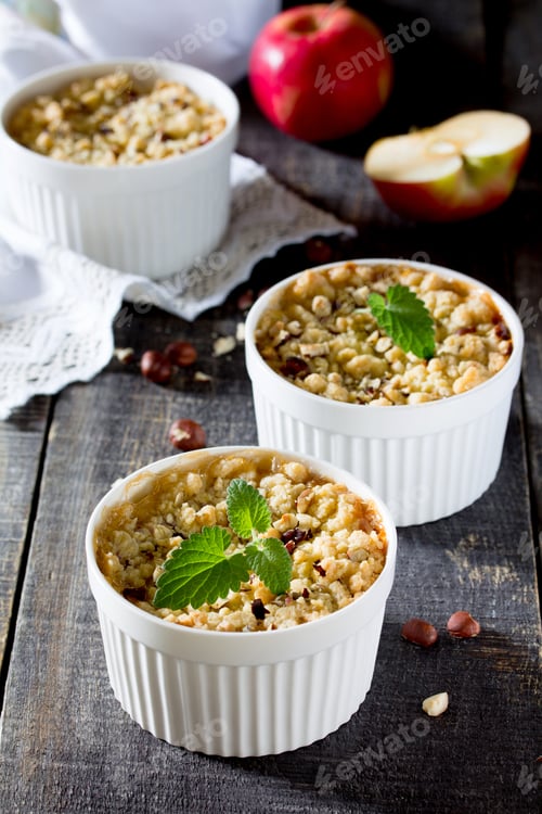 Preview: Dessert crumble with apple and nuts on a dark wooden table