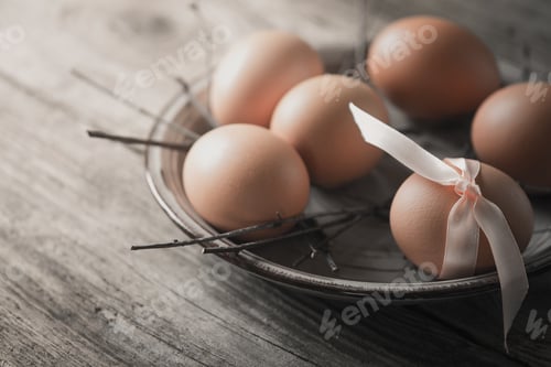 Preview: Eggs with ribbon and branches on the wooden table