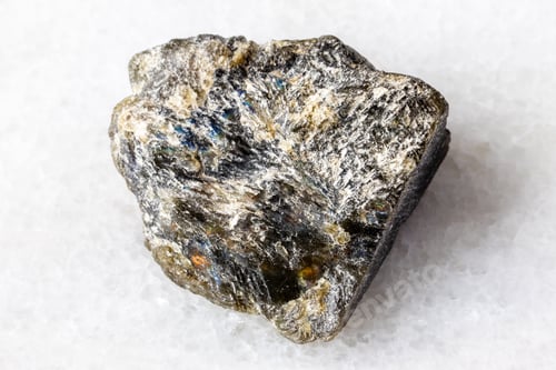 Preview: raw dark green labradorite mineral on white marble