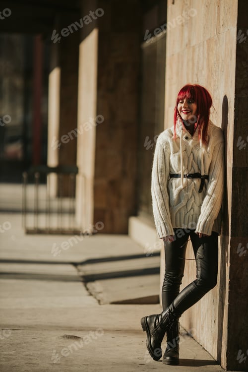 Preview: Vertical shot of a Caucasian red-haired woman leaned against the wall