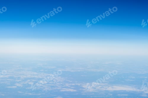 Preview: Beautiful view from the airplane porthole. blue sky, clouds, earth.