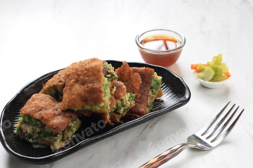 Preview: Martabak Telur is Popular Street Food in Indonesia. Egg, Spring Onion Wrapped with Thin Flour Batter