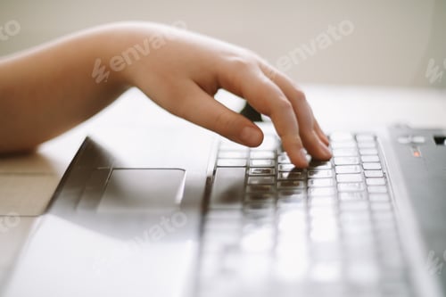 Preview: Close-up of male hands typing on laptop keyboard indoors. Businessman working in office or student