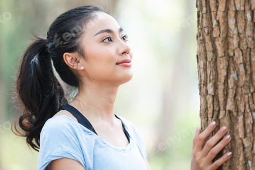 Preview: Asian woman using hands to hugging a tree in forest, Environment earth day or green sustainable