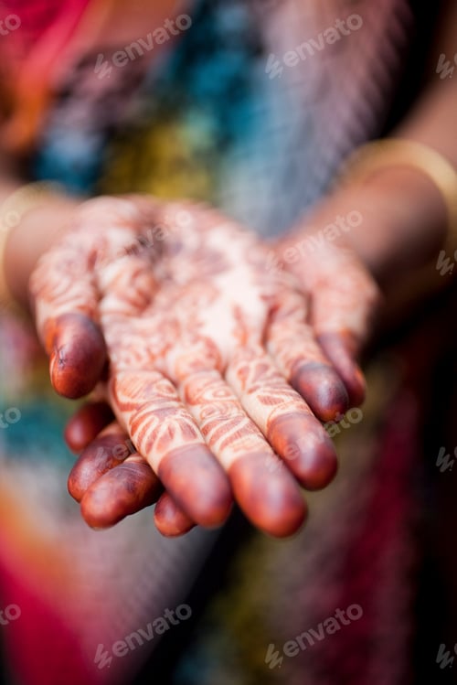 Preview: A cultural embrace captured through the intricate designs of henna art on welcoming hands.