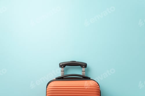 Preview: Need a summer getaway? Top view of an orange suitcase on a pastel blue background