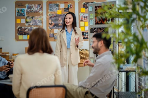 Preview: A man is holding a cardboard box and is standing in front of a white board. He is giving a presentat