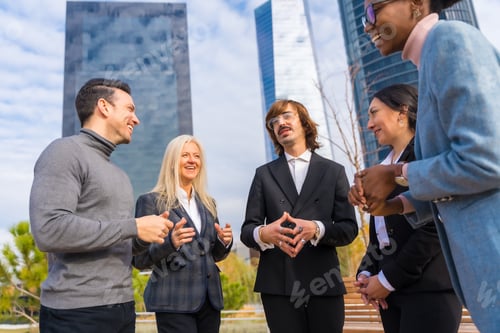 Preview: Middle-aged multi-ethnic businessmen and businesswomen, business park, talking to each other