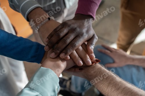 Preview: Pile of hands of multi-ethnic group of contemporary employees