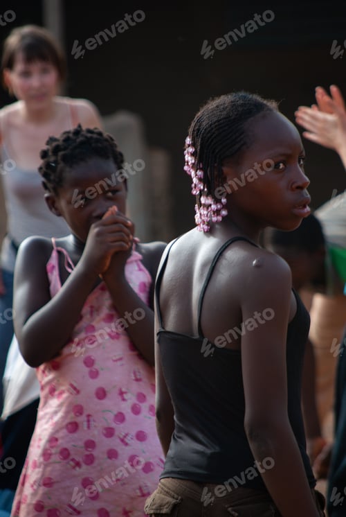Preview: Two young African girls dressed in pink - braided hair