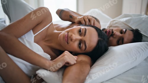 Preview: Relaxed man stroking woman hair at bed close up. Intimate couple laying together