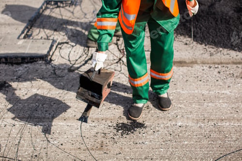 Preview: The man working asphalt pouring tar for road repair