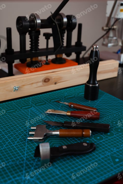 Preview: Craftsman leatherworking desk with tools for cutting, stitching, and carving