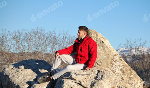 Preview: Selective focus shot of an attractive smiling man wearing a red coat