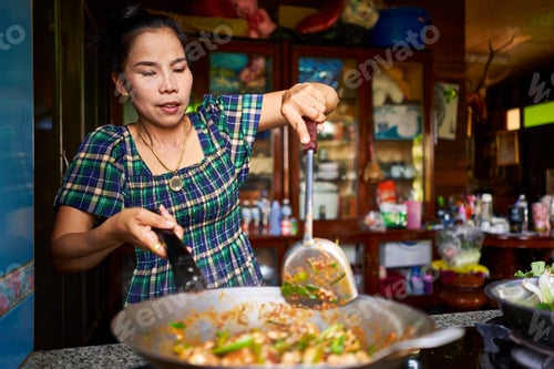 Preview: thai woman cooking traditional red curry in wok