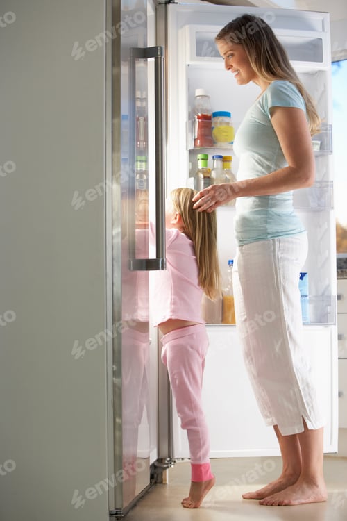 Preview: Mother And Daughter Choosing Snack From Fridge