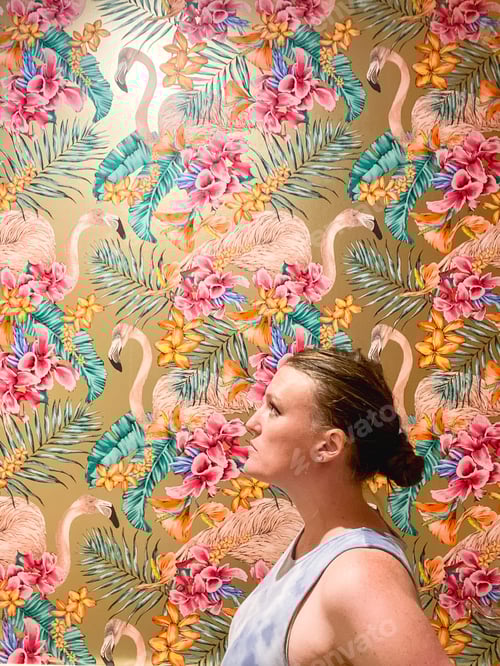 Preview: Portait of a millennial woman with bright and colorful flamingo wallpaper