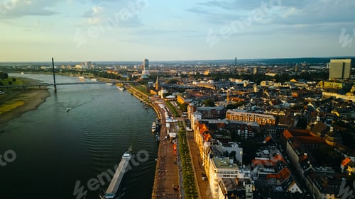 Preview: Aerial drone view of Dusseldorf city , buildings and city streets at sunset.
