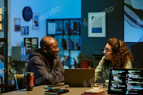 Preview: Young Adult Black Man and Young Adult Caucasian Man Collaborating in Office